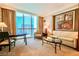 Cozy living room with a modern sofa, chair, and table, filled with natural light at 135 E Harmon Ave # 1703, Las Vegas, NV 89109