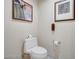 Small bathroom with a white toilet, decorative wallpaper, and framed artwork at 135 E Harmon Ave # 1703, Las Vegas, NV 89109