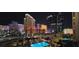 Aerial night view of a hotel and swimming pool at night at 135 E Harmon Ave # 407, Las Vegas, NV 89109
