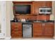 Compact kitchenette with modern appliances, cabinet storage and countertop space at 135 E Harmon Ave # 407, Las Vegas, NV 89109