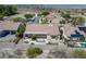 Aerial view of a well-maintained home featuring an outdoor firepit, spa, and desert landscaping at 1744 Williamsport St, Henderson, NV 89052