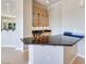 Stylish bar area featuring a black granite countertop, wood cabinetry, and convenient amenities at 1744 Williamsport St, Henderson, NV 89052