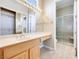 Bathroom features a large vanity, full mirror and a walk-in shower with a glass door at 1744 Williamsport St, Henderson, NV 89052