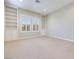 Spacious bedroom with neutral carpet, built-in bookcases and bright window shutters, great natural light at 1744 Williamsport St, Henderson, NV 89052