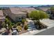 Well-maintained single-story home with stone accents, a tile roof, and lush landscaping at 1744 Williamsport St, Henderson, NV 89052