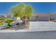 Single-story home featuring a landscaped front yard, stone accents, large driveway, and a 3-car garage at 1744 Williamsport St, Henderson, NV 89052