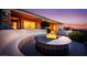 Inviting outdoor space with a modern fire pit, bench seating, and ambient lighting at 1744 Williamsport St, Henderson, NV 89052