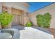 Inviting home entrance featuring stone accents, mature landscaping, and a decorative water feature at 1744 Williamsport St, Henderson, NV 89052
