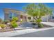Charming single-story home featuring a landscaped front yard, stone accents and a welcoming entrance at 1744 Williamsport St, Henderson, NV 89052