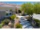Inviting front yard featuring desert landscaping, a paved walkway, and stone accents at 1744 Williamsport St, Henderson, NV 89052