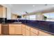 Open kitchen features a breakfast bar with granite counters and stainless steel dishwasher at 1744 Williamsport St, Henderson, NV 89052