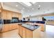 Beautiful kitchen with light wood cabinets, granite countertops, and a central island with a sink at 1744 Williamsport St, Henderson, NV 89052
