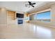 Modern living room with a fireplace, built-in shelving, and large windows overlooking a pool at 1744 Williamsport St, Henderson, NV 89052