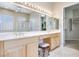 Bright bathroom with double vanity, large mirrors, and walk-in closet access at 1744 Williamsport St, Henderson, NV 89052
