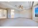 Spacious carpeted bedroom with tray ceiling and ceiling fan at 1744 Williamsport St, Henderson, NV 89052