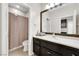 Well-lit bathroom featuring a wide mirror, neutral countertops, and shower with curtain at 2262 Alanhurst Dr, Henderson, NV 89052