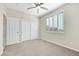 Comfortable bedroom featuring carpet, ceiling fan, window with shutter and sliding closet doors at 2262 Alanhurst Dr, Henderson, NV 89052
