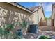 Exterior of home showcasing its side yard with plants and an air conditioner unit at 2262 Alanhurst Dr, Henderson, NV 89052
