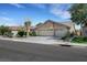 A well-manicured home featuring a three car garage and desert landscaping at 2262 Alanhurst Dr, Henderson, NV 89052