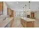 Well-lit kitchen with island, plenty of cabinetry, and tile flooring at 2262 Alanhurst Dr, Henderson, NV 89052