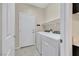 Functional laundry room featuring tile floors and modern washer and dryer set at 2262 Alanhurst Dr, Henderson, NV 89052