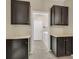 Well-lit laundry room features dark cabinets, light countertops, and modern appliances at 2262 Alanhurst Dr, Henderson, NV 89052