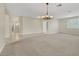 Open living space features tile entryway, neutral carpet, and contemporary lighting at 2262 Alanhurst Dr, Henderson, NV 89052