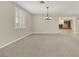 Inviting living room with neutral carpet, window shutters and easy access to other rooms at 2262 Alanhurst Dr, Henderson, NV 89052