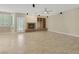 Spacious living room featuring a stone fireplace, built-in shelves, tile floors and a ceiling fan at 2262 Alanhurst Dr, Henderson, NV 89052