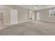 Large main bedroom with neutral carpet, ceiling fan, shuttered windows, and access to ensuite at 2262 Alanhurst Dr, Henderson, NV 89052