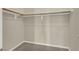 Open walk-in closet with gray carpet and wooden shelves providing plenty of storage at 2262 Alanhurst Dr, Henderson, NV 89052