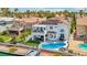 Beautiful backyard featuring a pool, lounge area, and waterfront access with a private dock at 2469 Sun Reef Rd, Las Vegas, NV 89128