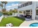 Backyard oasis with a lush lawn, stylish patio furniture, and a pool, creating the perfect space for relaxation and play at 2469 Sun Reef Rd, Las Vegas, NV 89128