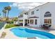 Expansive backyard with a pool, patio, turf, and balcony, designed for relaxation and outdoor entertainment at 2469 Sun Reef Rd, Las Vegas, NV 89128
