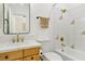 Bathroom featuring a wood vanity with marble countertop and shower/tub combo with gold fixtures at 2469 Sun Reef Rd, Las Vegas, NV 89128