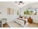 Bright bedroom features a ceiling fan, large windows, and neutral decor, creating a relaxing atmosphere at 2469 Sun Reef Rd, Las Vegas, NV 89128