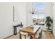Bright dining room features modern chandelier, natural light, and views of outdoor pool at 2469 Sun Reef Rd, Las Vegas, NV 89128