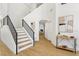 Inviting entryway with a staircase, wood flooring, and modern decor at 2469 Sun Reef Rd, Las Vegas, NV 89128