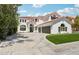 Two-story home with a well-maintained lawn, stucco exterior, tile roof, and multi-car driveway at 2469 Sun Reef Rd, Las Vegas, NV 89128
