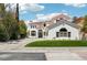 Elegant two-story home showcasing a terracotta tile roof, stucco exterior, and beautifully landscaped front yard at 2469 Sun Reef Rd, Las Vegas, NV 89128