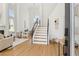 Bright, modern foyer with soaring ceilings, staircase, and open living area with fireplace at 2469 Sun Reef Rd, Las Vegas, NV 89128