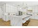 Beautiful kitchen featuring an island with marble countertop, white cabinets, and gold hardware at 2469 Sun Reef Rd, Las Vegas, NV 89128