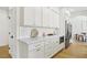 Bright kitchen with white cabinets, marble countertops, gold hardware, and stainless steel appliances at 2469 Sun Reef Rd, Las Vegas, NV 89128