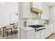 Well-lit kitchen with stainless steel appliances, marble counters, and access to dining area at 2469 Sun Reef Rd, Las Vegas, NV 89128
