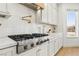 Modern kitchen featuring white cabinets, stainless steel appliances, and a pot filler faucet at 2469 Sun Reef Rd, Las Vegas, NV 89128