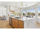 Gourmet kitchen with large marble island, stainless appliances, and views of the backyard at 2469 Sun Reef Rd, Las Vegas, NV 89128