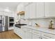 Modern kitchen featuring white cabinets, stainless steel appliances, and marble countertops at 2469 Sun Reef Rd, Las Vegas, NV 89128