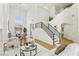 Modern living room with fireplace, high ceilings, a staircase, and open access to the dining area at 2469 Sun Reef Rd, Las Vegas, NV 89128
