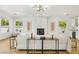 Bright living room with fireplace, modern chandelier, and an open floorplan at 2469 Sun Reef Rd, Las Vegas, NV 89128