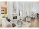 Bright living space with high ceilings, marble fireplace, stylish furnishings, and adjacent dining area at 2469 Sun Reef Rd, Las Vegas, NV 89128
